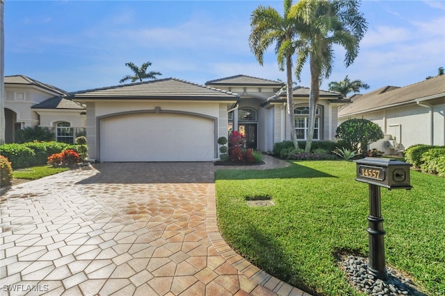 view of front of home with a garage and a front lawn