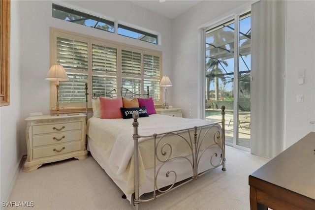 bedroom featuring multiple windows, light colored carpet, and access to exterior