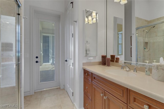 bathroom with vanity, an enclosed shower, and tile patterned floors