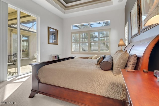 bedroom featuring crown molding, a tray ceiling, access to outside, and carpet