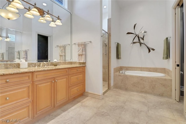 bathroom with a towering ceiling, vanity, shower with separate bathtub, and tile patterned floors