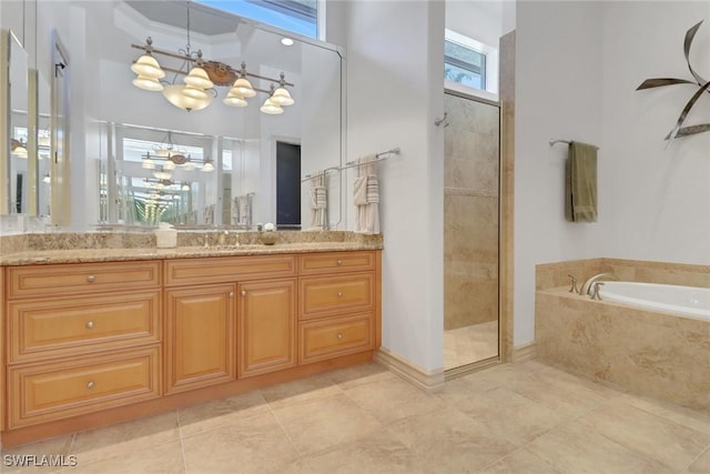 bathroom with an inviting chandelier, vanity, crown molding, and separate shower and tub