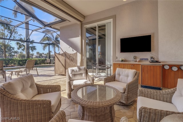 view of patio / terrace with an outdoor kitchen and glass enclosure