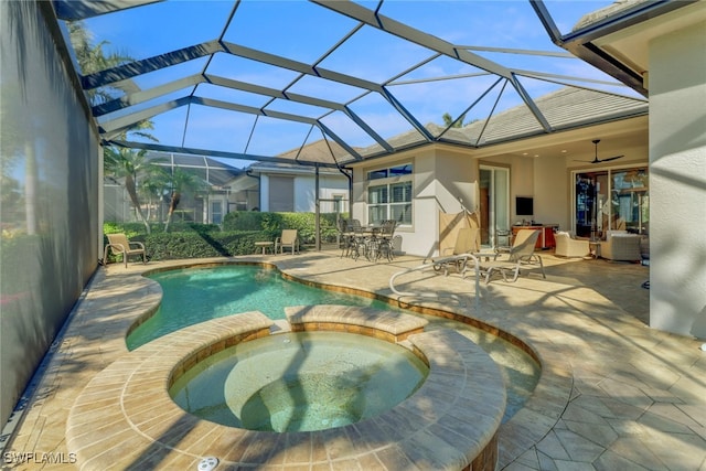 view of swimming pool with a patio, glass enclosure, and an in ground hot tub