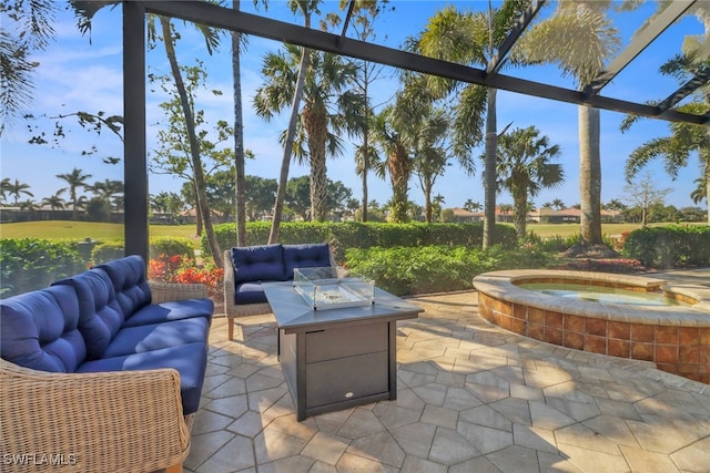 view of patio / terrace with an in ground hot tub and an outdoor living space with a fire pit