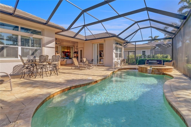 view of pool featuring an in ground hot tub, ceiling fan, glass enclosure, and a patio