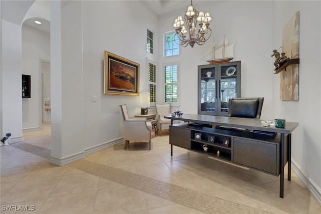 office with a notable chandelier, a high ceiling, and light tile patterned floors