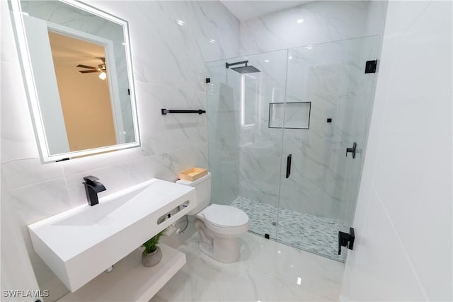 bathroom with tile walls, sink, a shower with shower door, and toilet