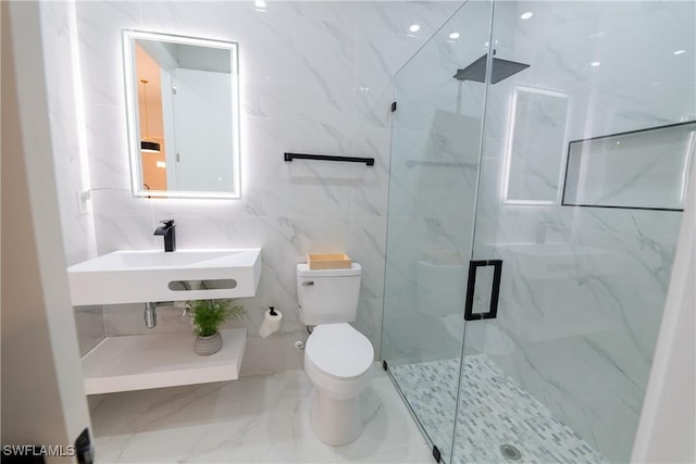 bathroom with walk in shower, sink, and toilet