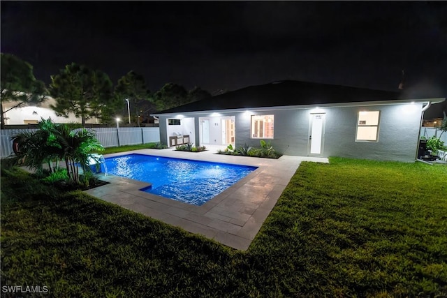 view of swimming pool with a patio, a lawn, and pool water feature