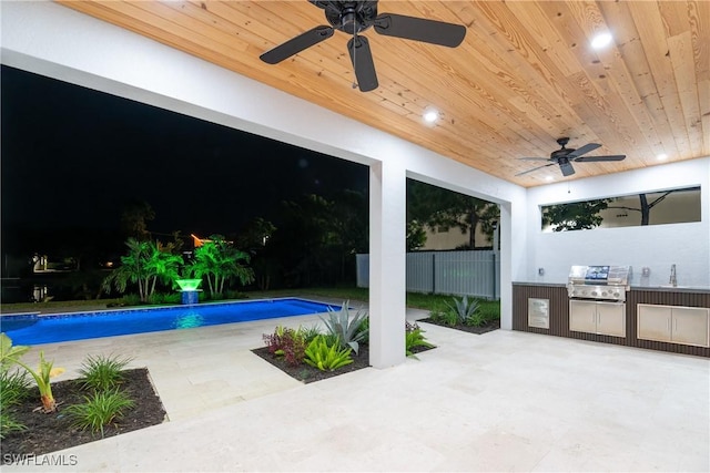 exterior space featuring ceiling fan, a grill, and exterior kitchen