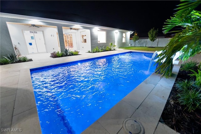 view of pool featuring pool water feature, ceiling fan, and a patio