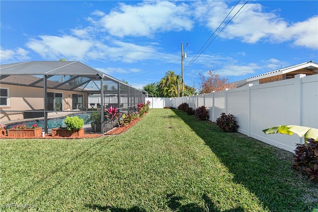 view of yard with a fenced in pool and a lanai