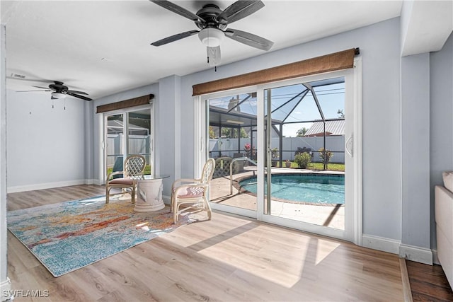 interior space with wood-type flooring and ceiling fan