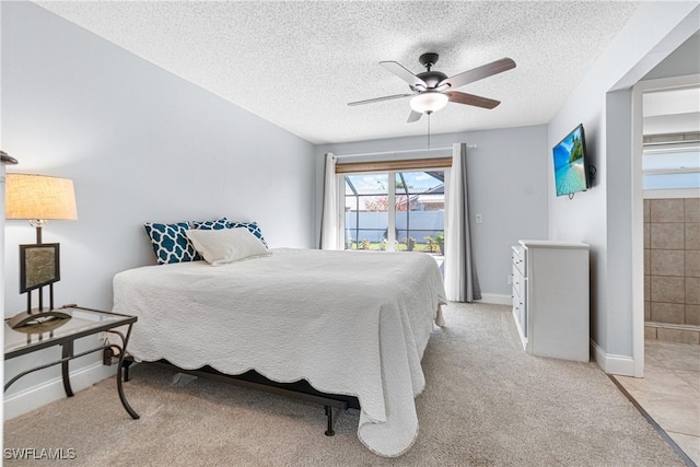 bedroom with ceiling fan, light carpet, access to exterior, and a textured ceiling