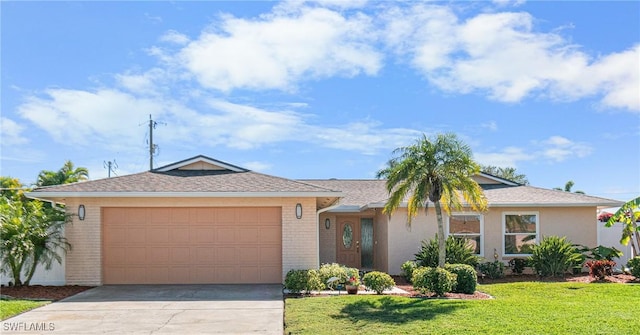 ranch-style home featuring a garage and a front yard