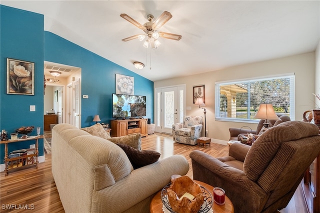 living room with vaulted ceiling, ceiling fan, and light hardwood / wood-style floors