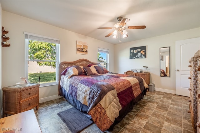 bedroom with ceiling fan and multiple windows