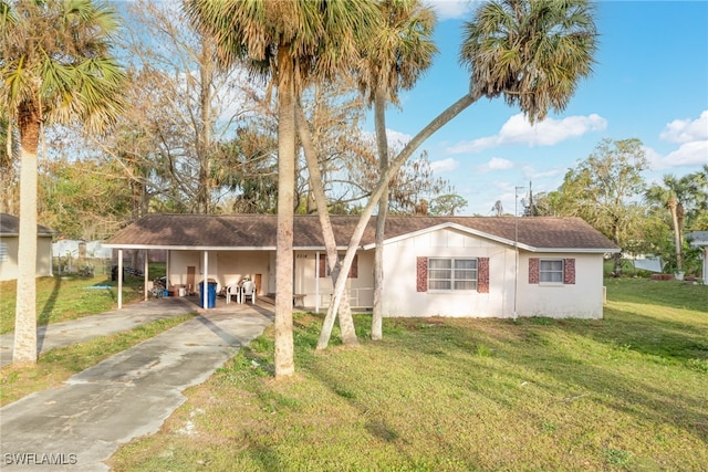 view of front facade with a front yard and a carport