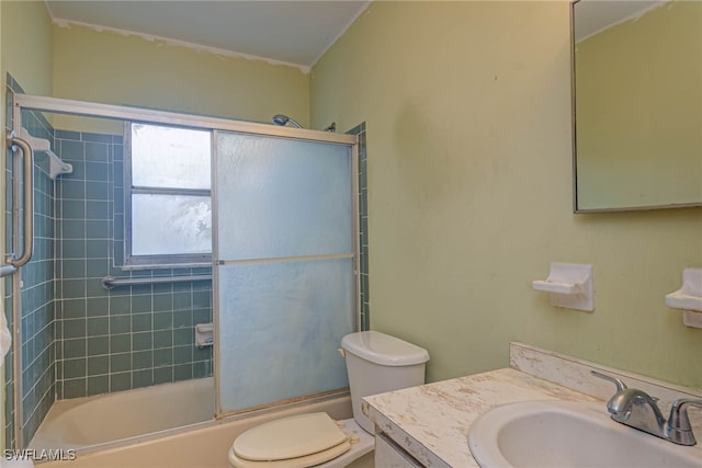 full bathroom with enclosed tub / shower combo, vanity, and toilet