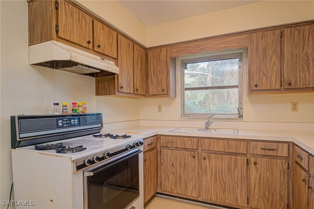 kitchen featuring sink and white gas range oven