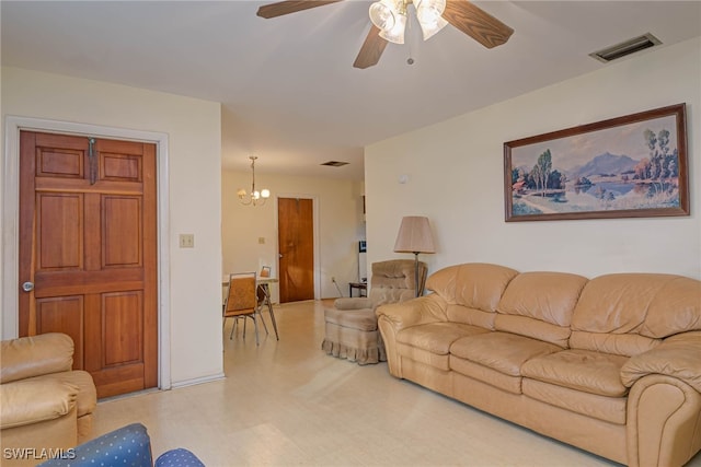 living room featuring ceiling fan with notable chandelier