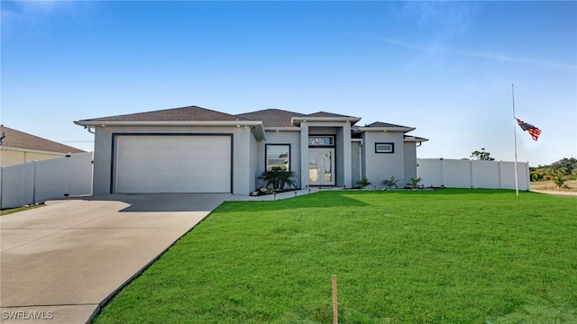 view of front of property with a garage and a front lawn