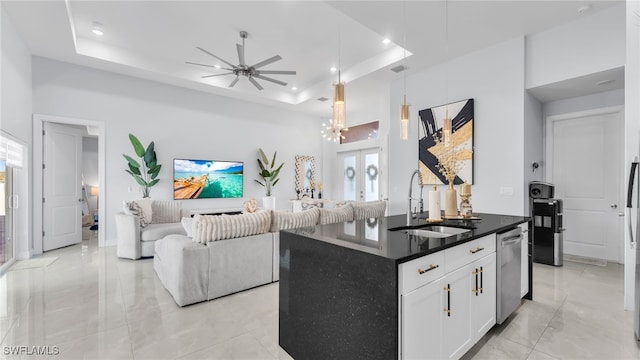 kitchen with sink, white cabinets, a center island, stainless steel dishwasher, and a raised ceiling