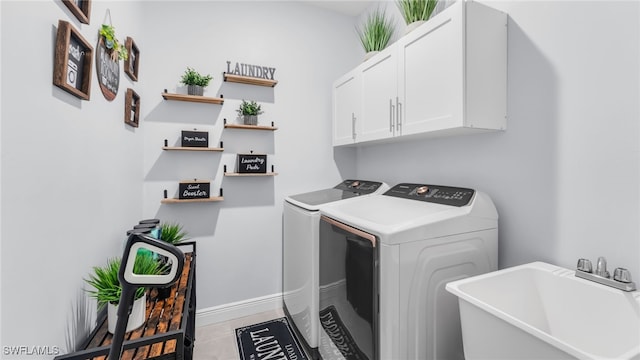 laundry area featuring cabinets, separate washer and dryer, and sink