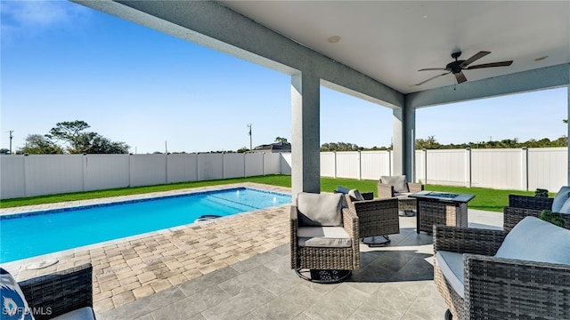 view of swimming pool featuring a patio, outdoor lounge area, and ceiling fan