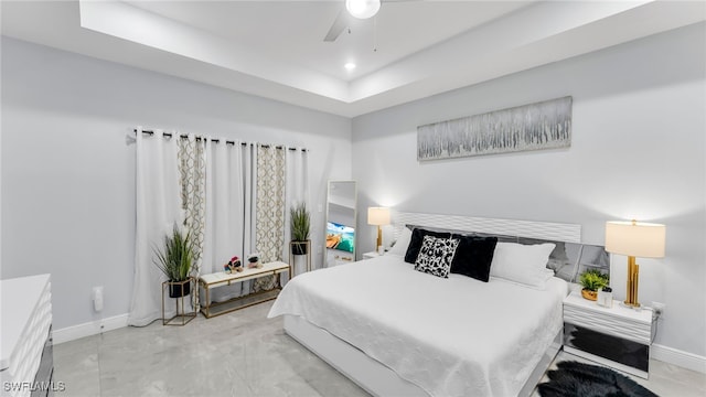 bedroom featuring a tray ceiling and ceiling fan