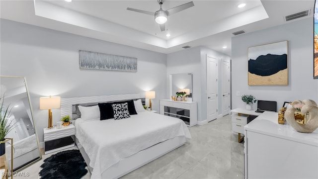 bedroom featuring ceiling fan and a tray ceiling