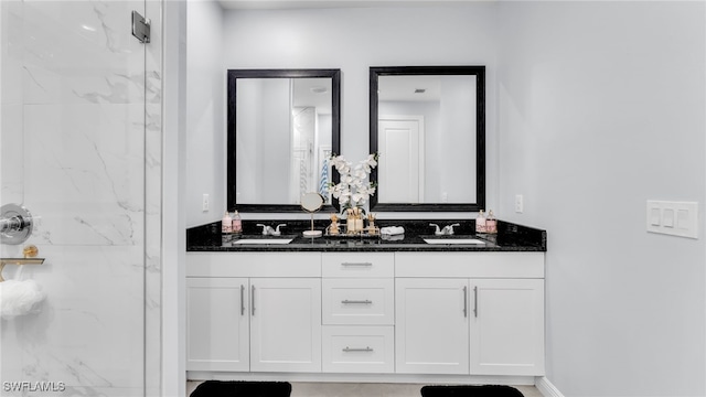 bathroom with vanity and a shower