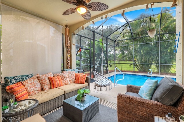 view of swimming pool with ceiling fan, outdoor lounge area, a patio area, and a lanai