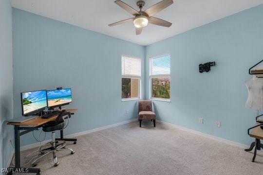 carpeted office featuring ceiling fan