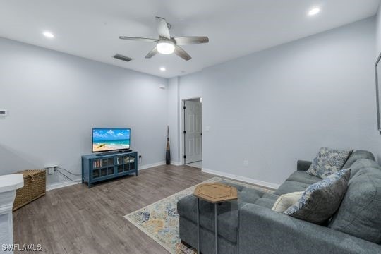 living room featuring ceiling fan and wood-type flooring