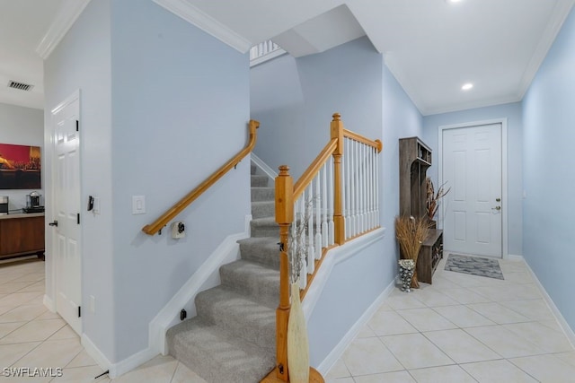 staircase featuring crown molding and tile patterned floors