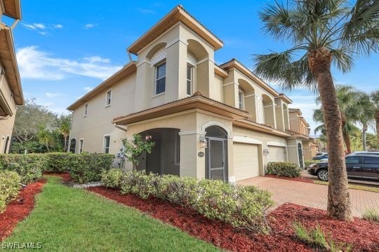 mediterranean / spanish-style home with a garage and a front yard