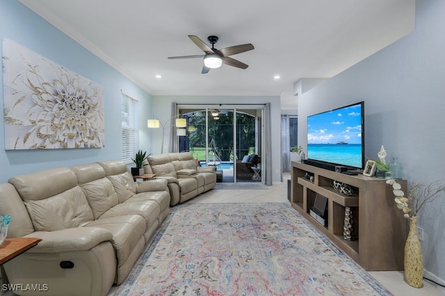 living room with ornamental molding, ceiling fan, and light tile patterned flooring