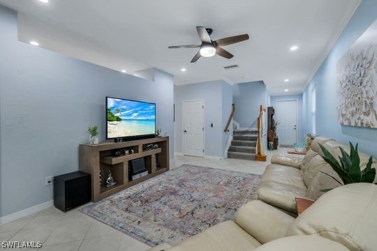 tiled living room featuring ceiling fan