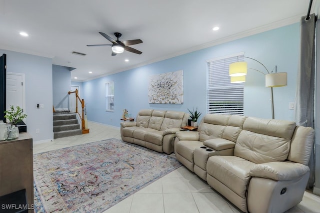 living room with light tile patterned flooring, ornamental molding, and ceiling fan