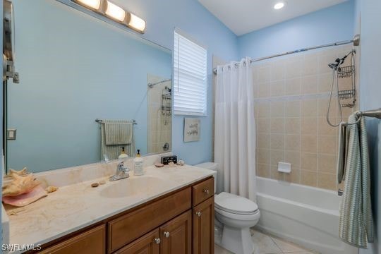 full bathroom featuring vanity, tile patterned floors, shower / bath combination with curtain, and toilet