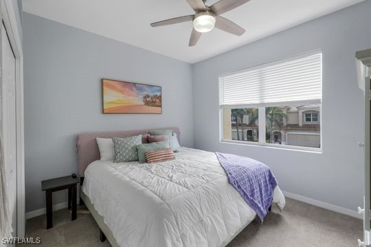 carpeted bedroom featuring ceiling fan