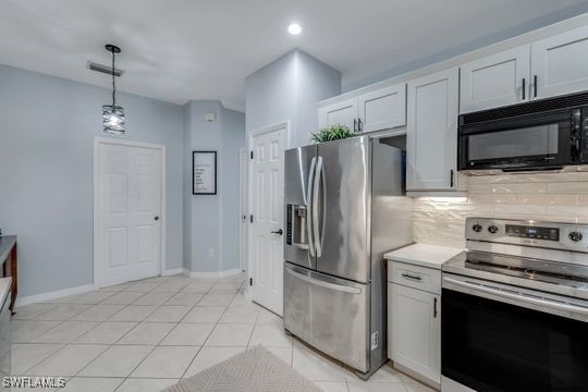 kitchen featuring white cabinetry, decorative light fixtures, decorative backsplash, and appliances with stainless steel finishes