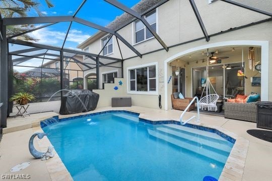 view of pool with pool water feature, a lanai, an outdoor hangout area, and a patio area