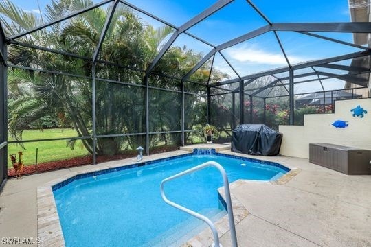 view of swimming pool featuring grilling area, a patio, pool water feature, and glass enclosure