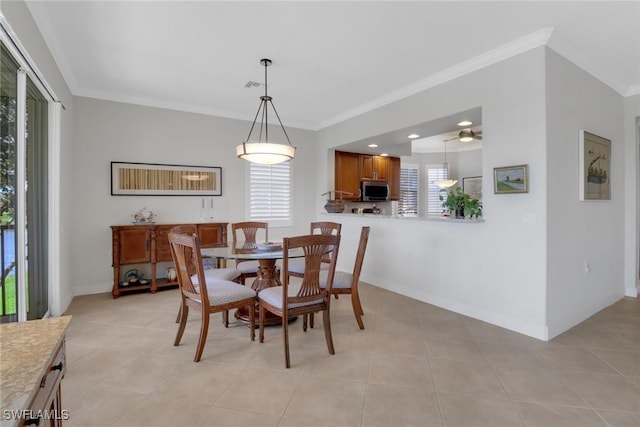 dining area featuring light tile patterned floors and crown molding