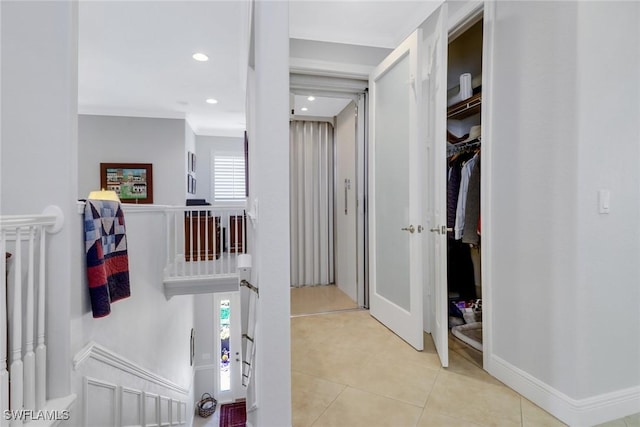 corridor with light tile patterned floors and a healthy amount of sunlight