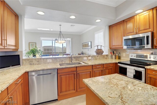 kitchen with light stone counters, sink, plenty of natural light, and appliances with stainless steel finishes