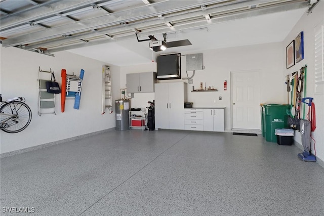 garage featuring water heater and a garage door opener